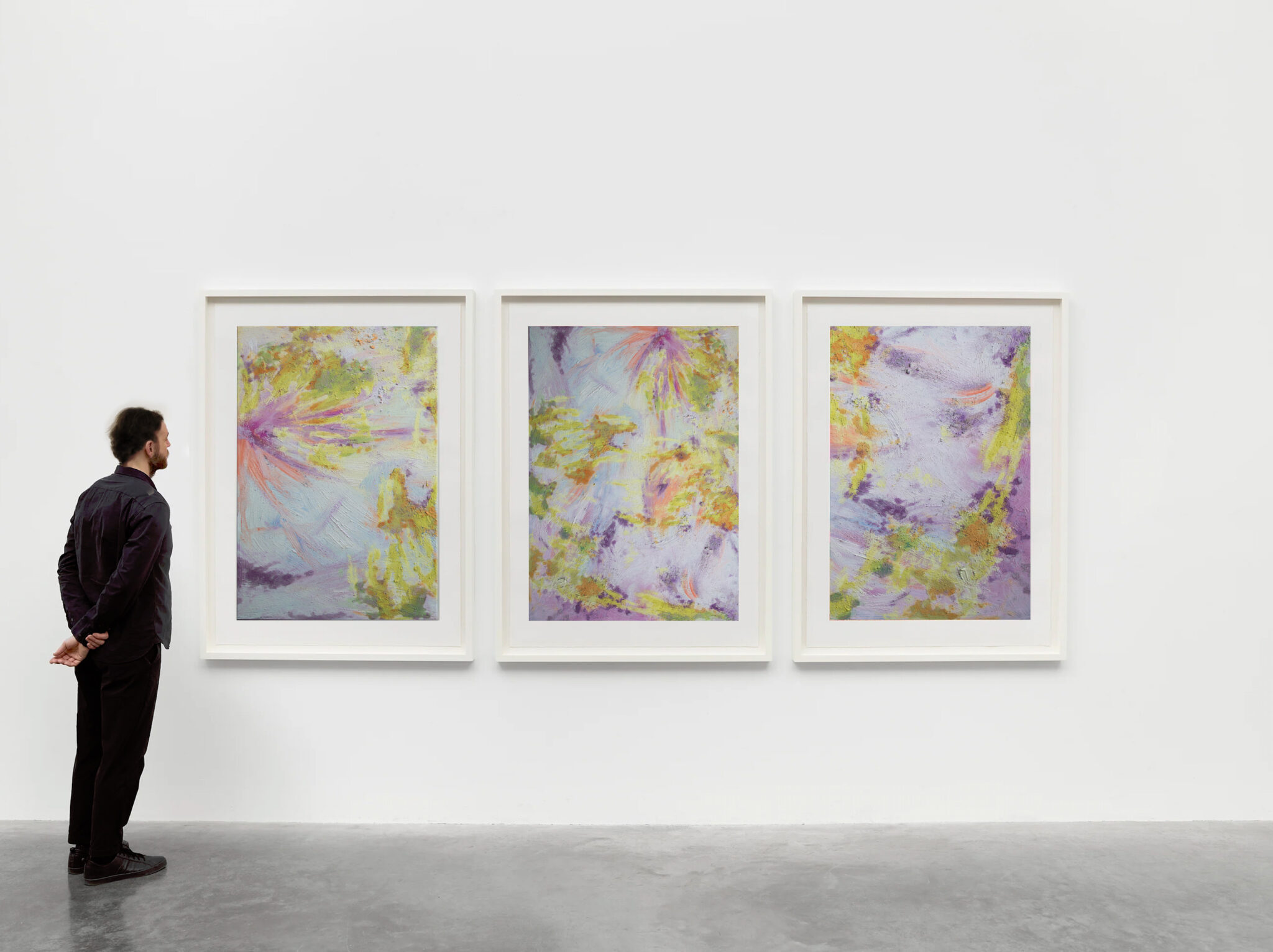 Male Viewer Admiring a tryptic artwork created by the artist Ornella Gallo Di Fortuna on colourful brushstrokes on white frames on withe walls